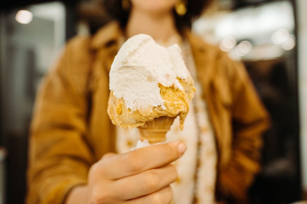 A woman holding a cone with gelato in Italy. 