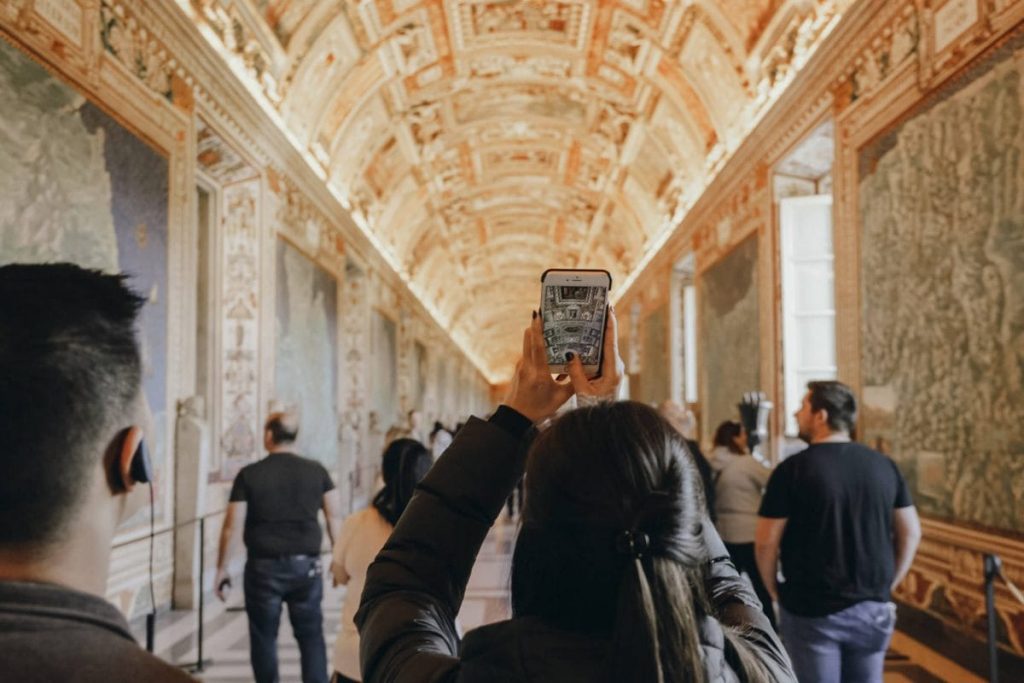 People taking photos inside the Vatican in Rome. 